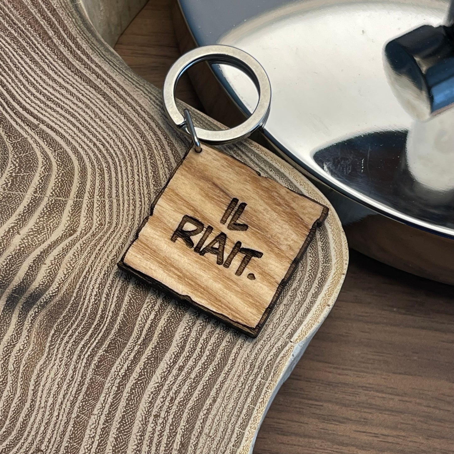 “HE LAUGHED” keychain.